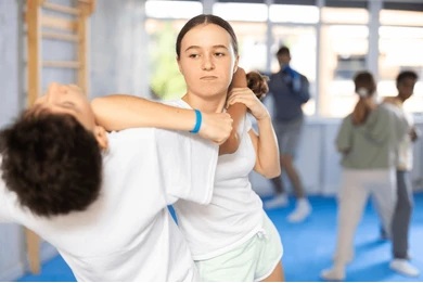 Instructor teaching Taekwondo self-defense techniques, highlighting the benefits of Taekwondo for protection.